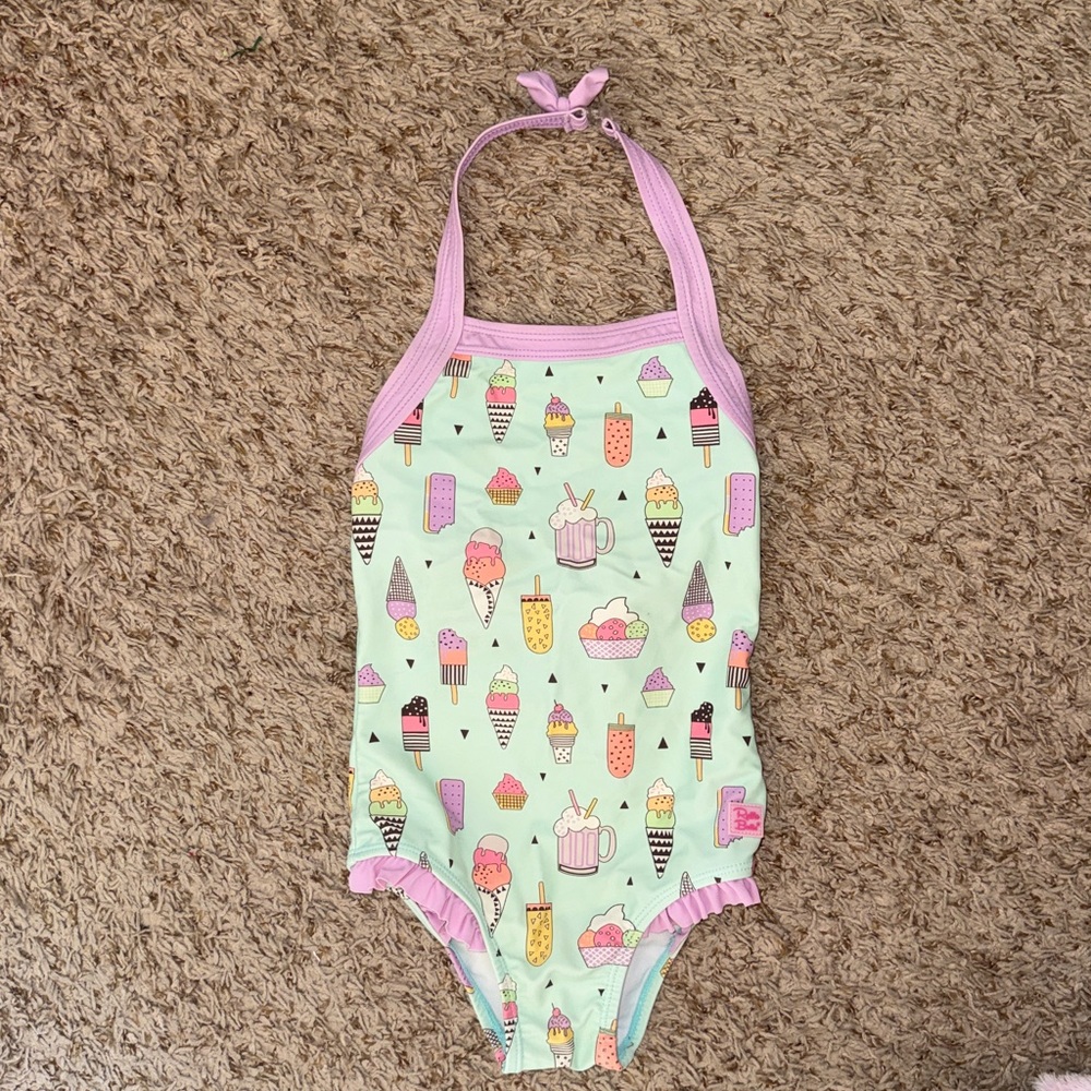 4t girls Ruffle Butts halter style one-piece swim suit with nice cream print.